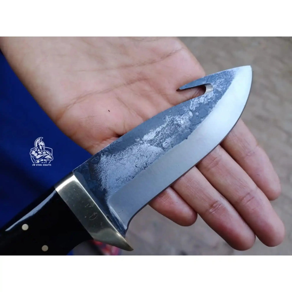 Gut hook knife with wood and brass handle.